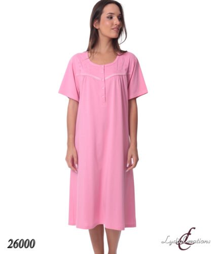 Pink knee-length sleep dress with short sleeves and lacey yoke, model standing against a white background.