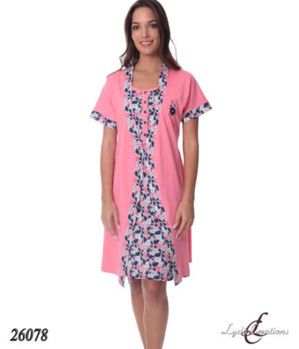 Model wearing a pink knee-length cardigan-style dress with a navy floral print panel down the center and matching sleeve trim.