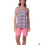 Woman modeling a navy floral sleeveless top with pink flowers paired with pink shorts against a white background.