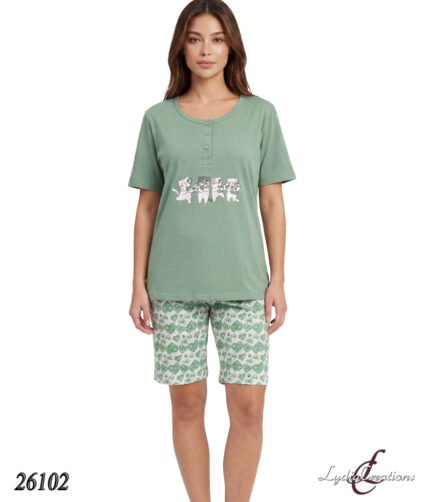 Model wearing a sage green short-sleeve pajama top with a cat graphic and matching patterned green shorts.