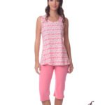 Model wearing a white sleeveless top with a pink heart pattern and pink knee-length capri pants, studio shot